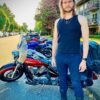 作者穿着蝎子EXO隐蔽Ultra牛仔裤站在旁边一行停放的摩托车